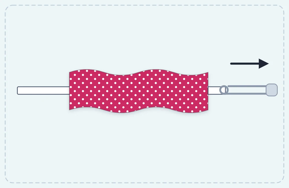 A fabric tube with elastic being threaded through it using a safety pin