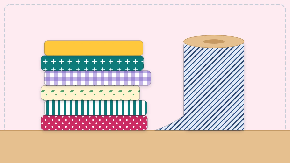 Stack of folded cotton fabrics in different prints beside a fabric bolt