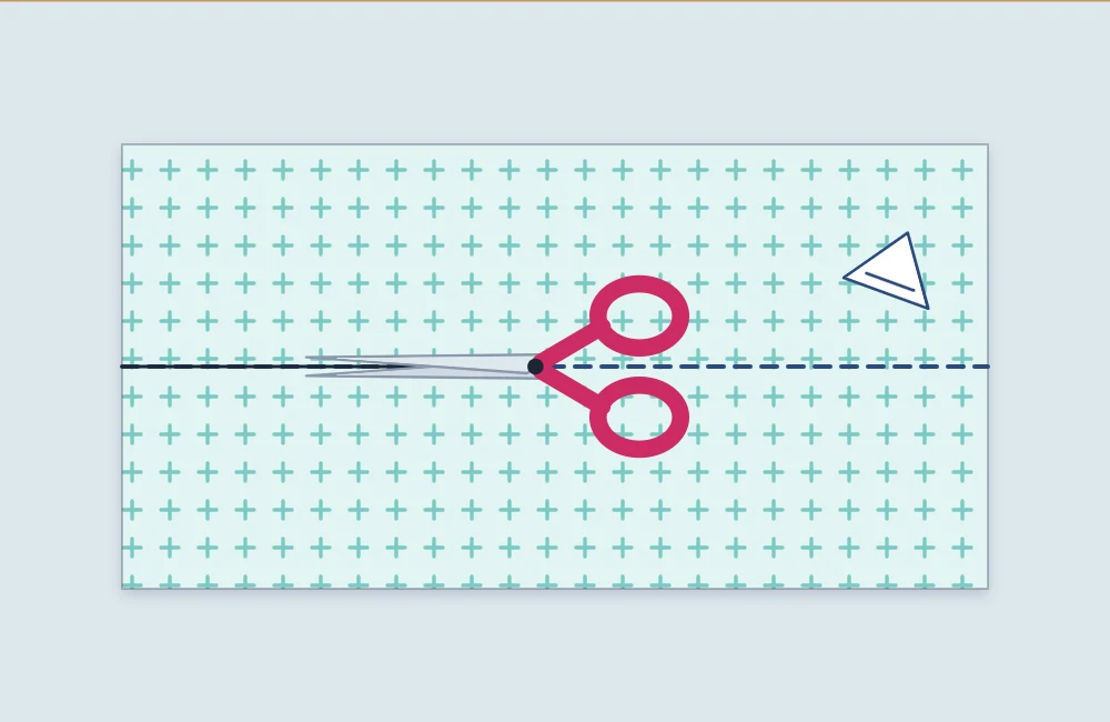 Scissors cutting along a marked chalk line on fabric lying flat