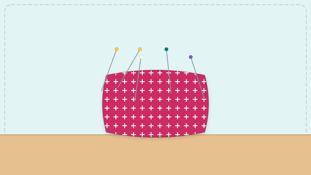A square fabric pincushion with several pins stuck in the top